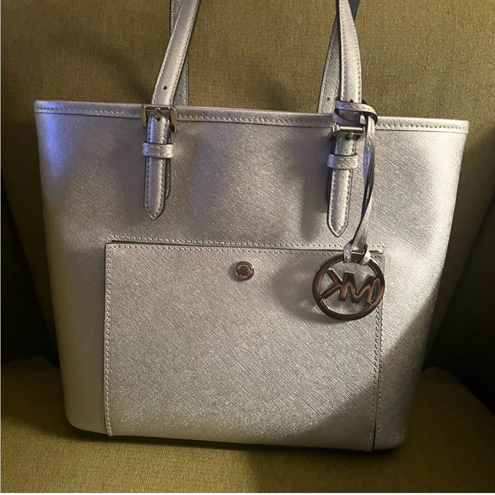 Beautiful silver handbag. 12X 91/2 inches. 8 inch drop. Great condition.